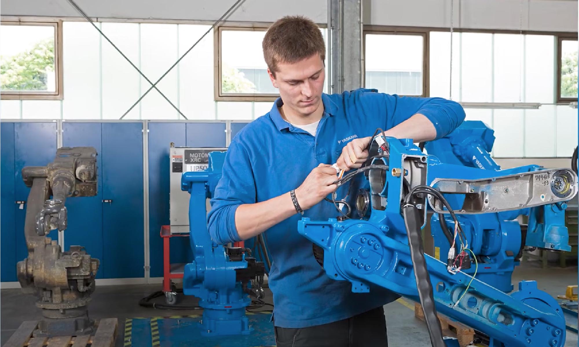 Yaskawa certified technician servicing an industrial robot
